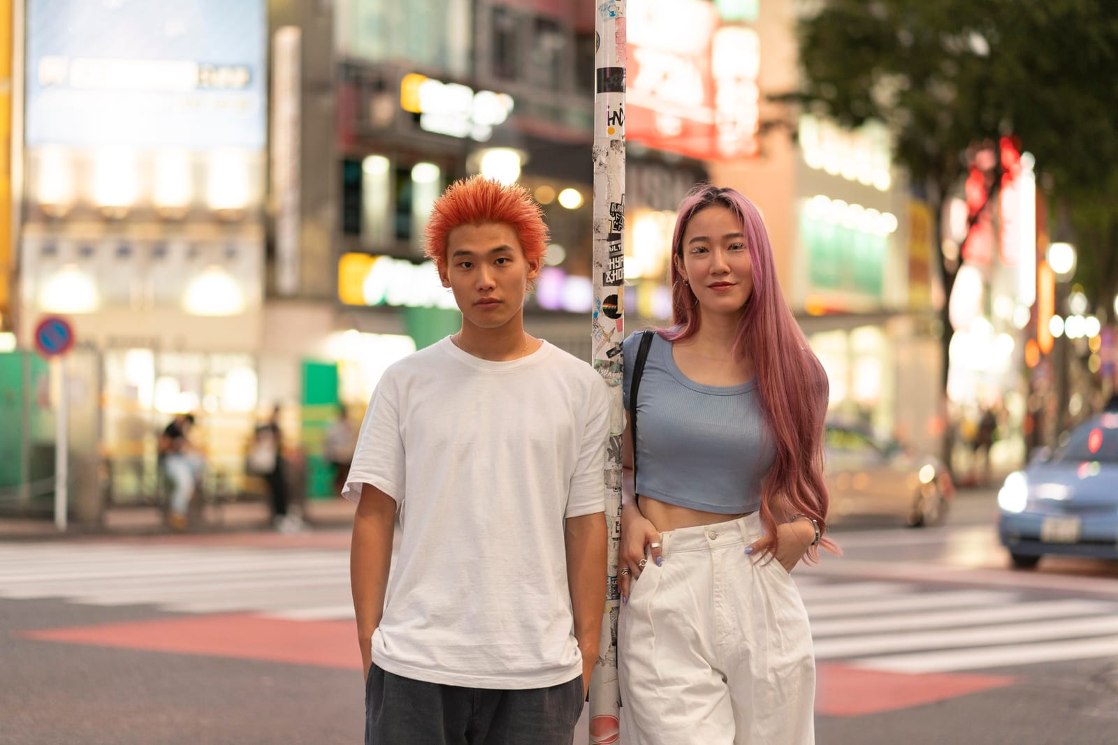 日本の路地を歩く笑顔の若い男性。